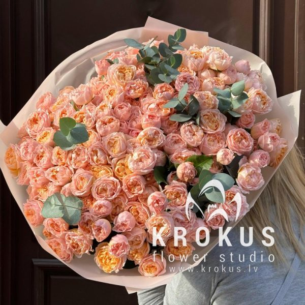 A bouquet of peach spray peony roses with eucalyptus
